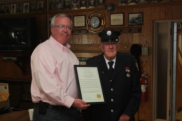 Mayor John McCormac presents Frank Meyer with a proclamation for his 50 years of service to the community