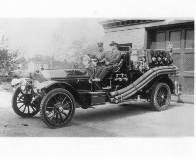 First motorized apparatus. Harry Mawbey at wheel with Harry Turner.